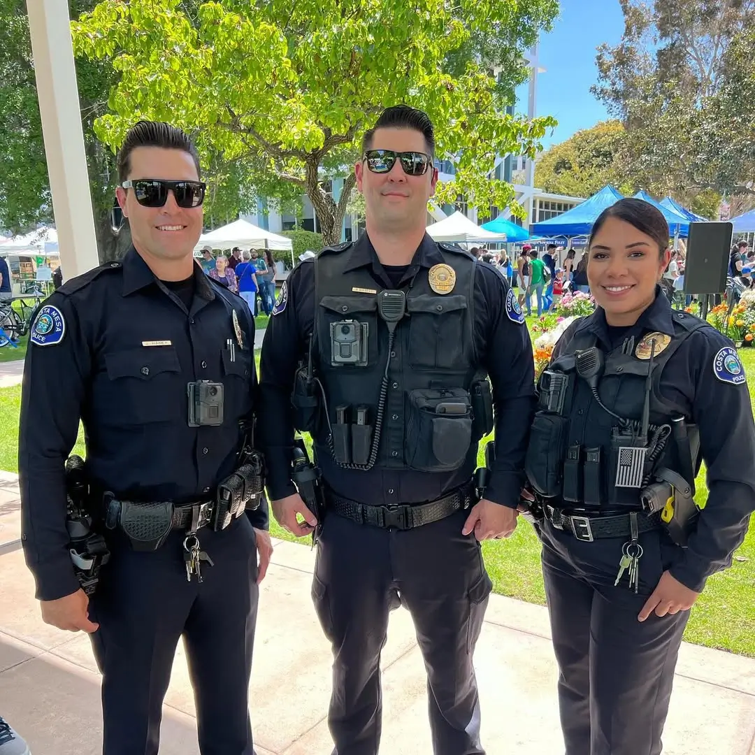 Three Costa Mesa Police officers smiling at Earth Day Festival community event
