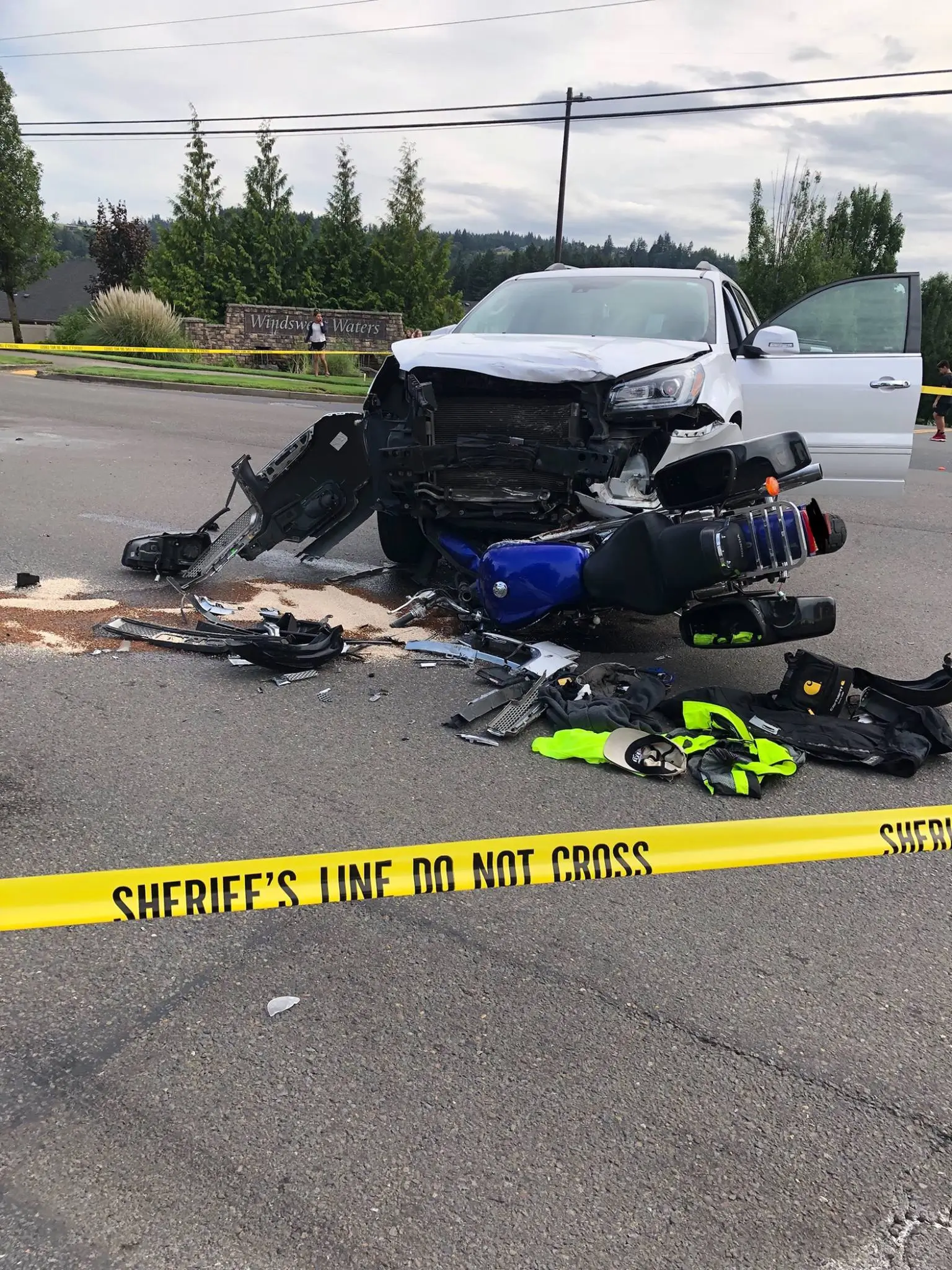 Fatal motorcycle crash scene with damaged SUV and motorcycle debris
