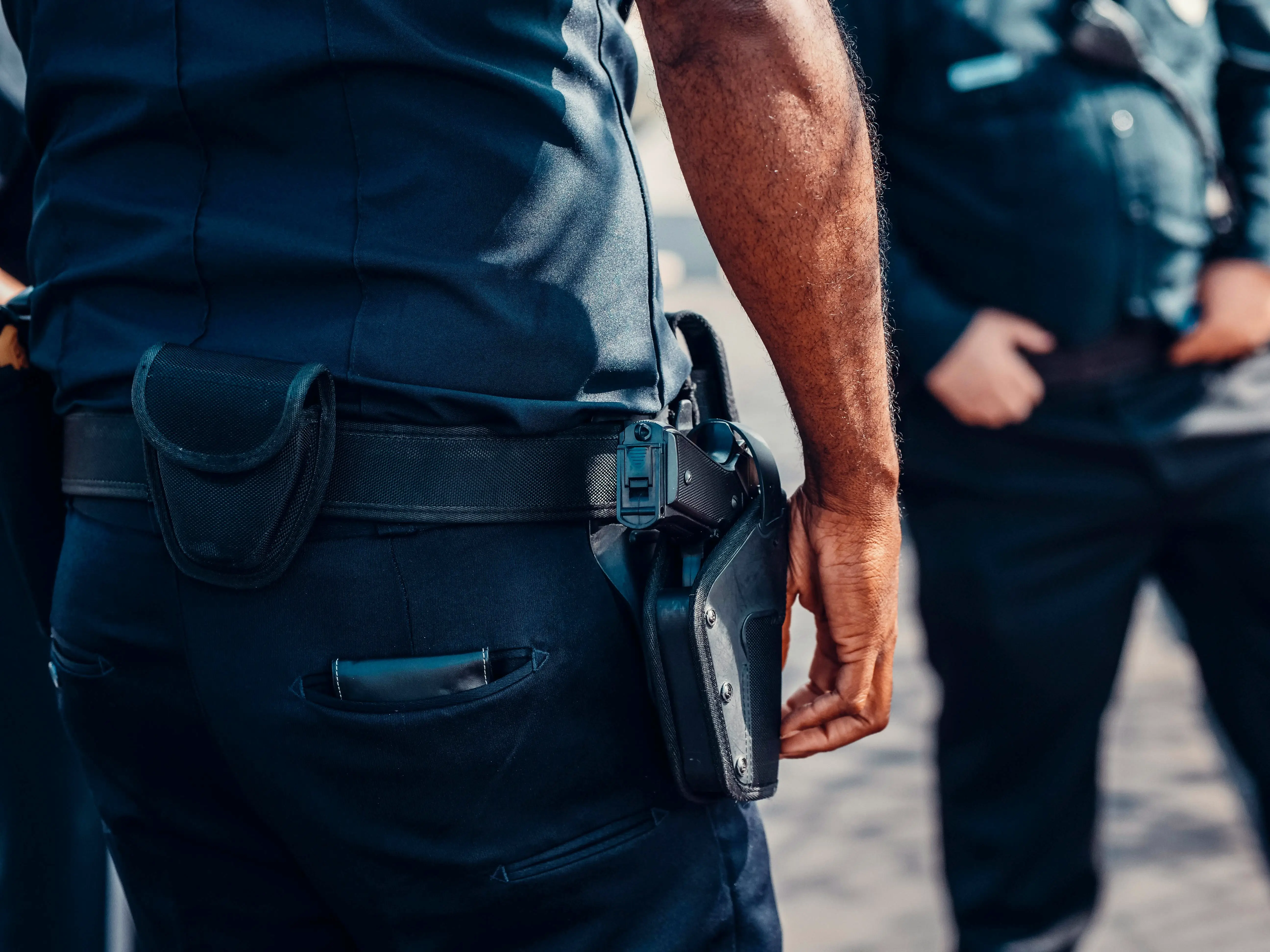 Close-up of police officer's duty belt showing holster and equipment