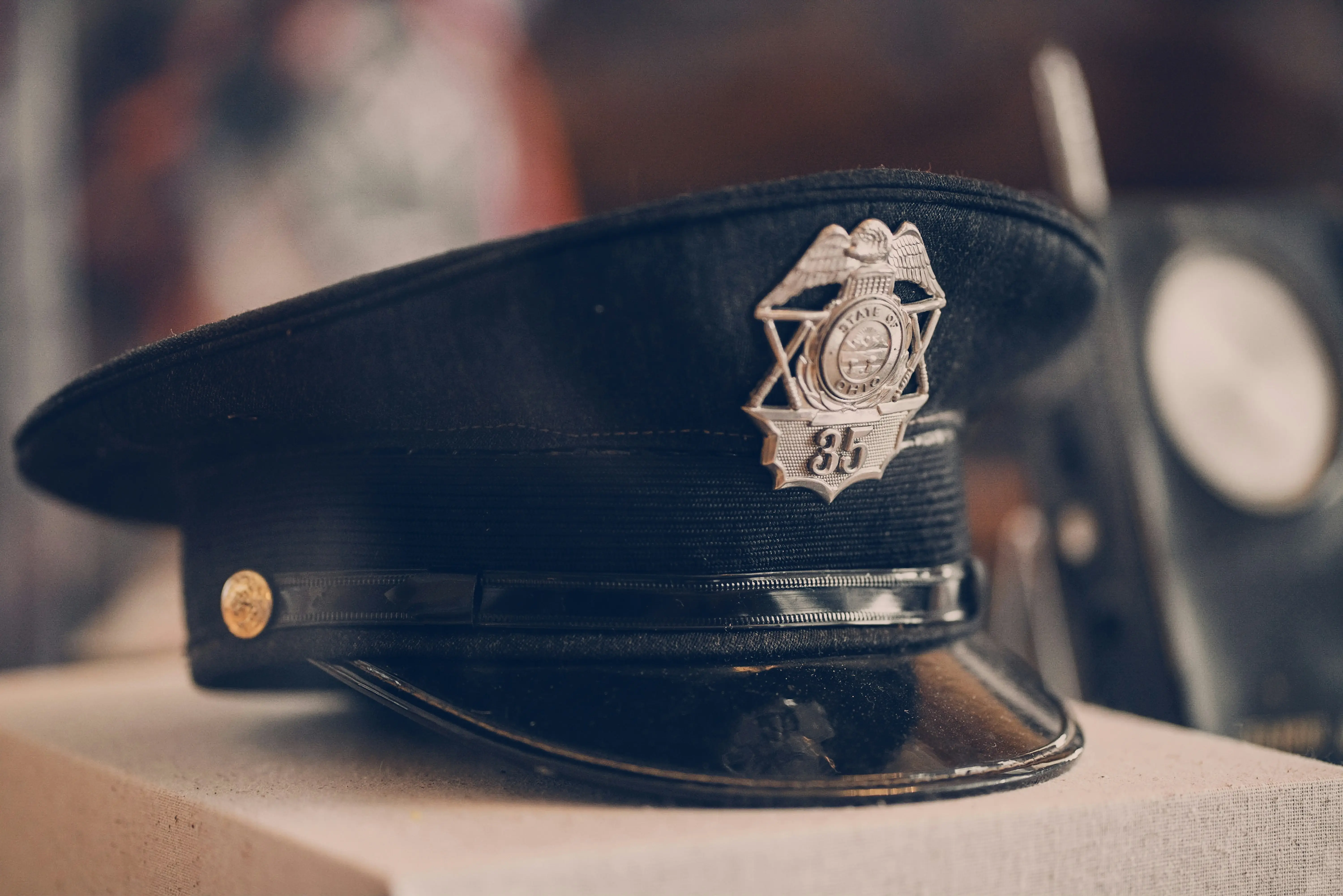 Close-up of police officer's uniform cap with badge number 35