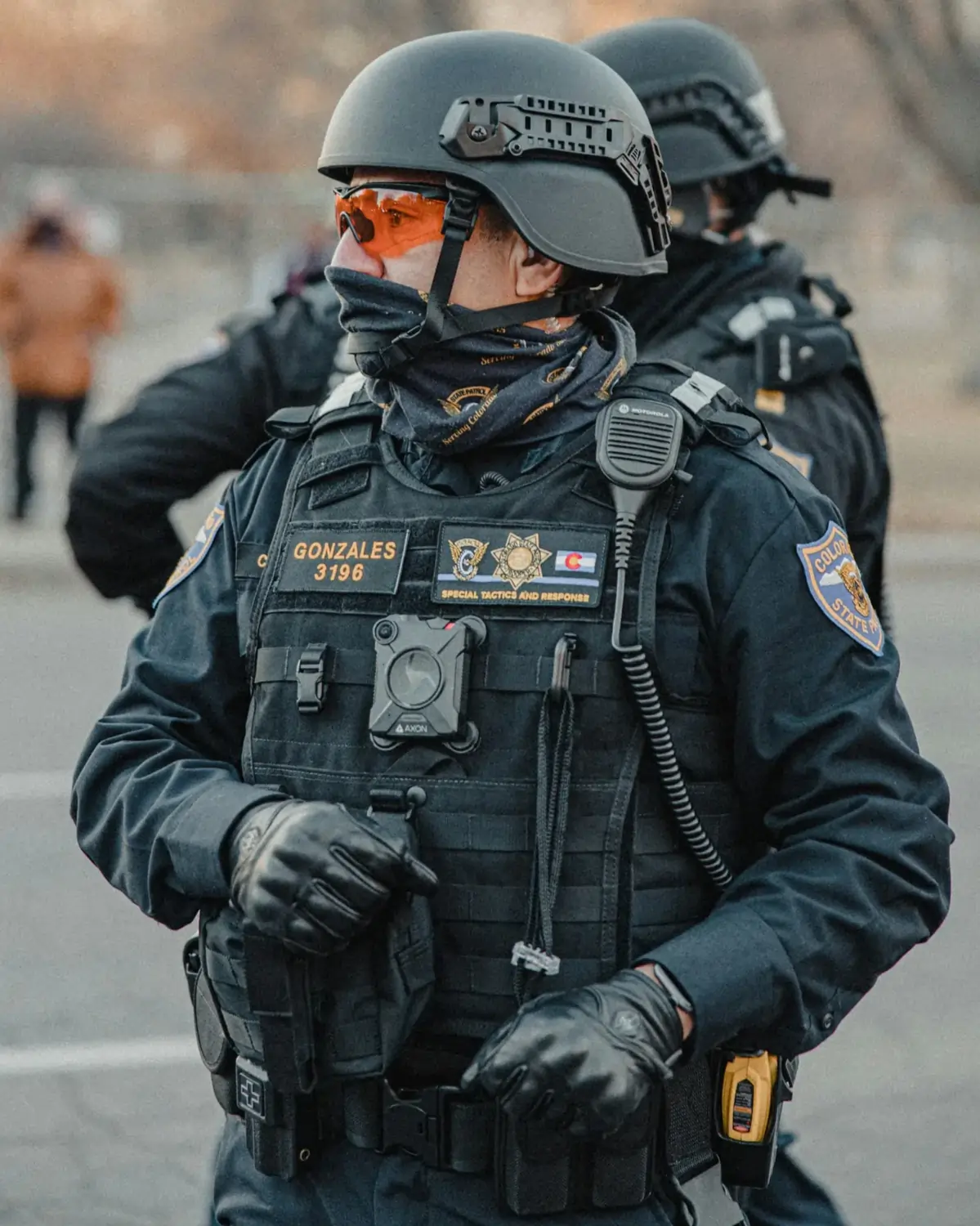 Tactical police officer in full protective gear including helmet and body camera during patrol
